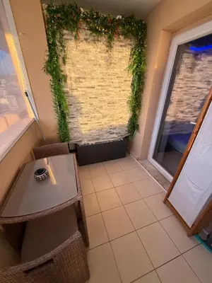 a room with a table and a window with plants at Azuria in Cannes
