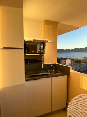 a kitchen with a sink and a view of the ocean at Azuria in Cannes