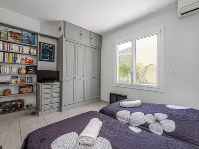 a bedroom with two beds and a window at Apartment Les Girelles by Interhome in Cannes
