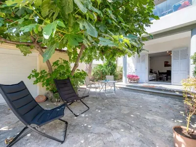a patio with two chairs and a tree at Apartment Les Girelles by Interhome in Cannes