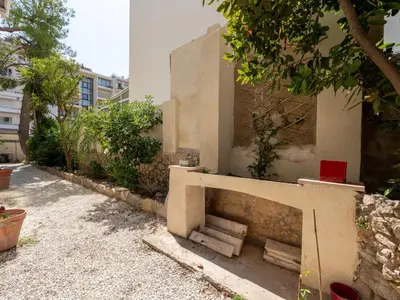 a concrete wall with a bench on a street at Apartment Les Girelles by Interhome in Cannes