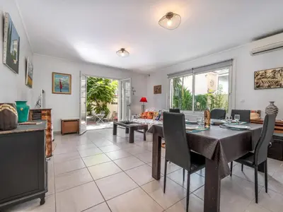 a living room with a table and a couch at Apartment Les Girelles by Interhome in Cannes
