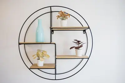 a metal shelf with three potted plants and a mirror at Studio Jasmin - calme charmant clim Palais & plage in Cannes