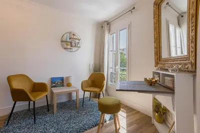 a living room with yellow chairs and a mirror at Studio Jasmin - calme charmant clim Palais & plage in Cannes