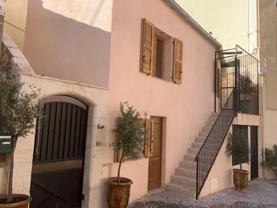 a building with a staircase and a door and some plants at Chante Brise 2 Pieces in Cannes