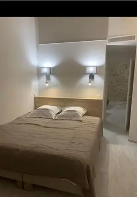 a bedroom with a large bed with two pillows at Chante Brise 2 Pieces in Cannes