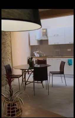 a kitchen and dining room with a table and chairs at Chante Brise 2 Pieces in Cannes