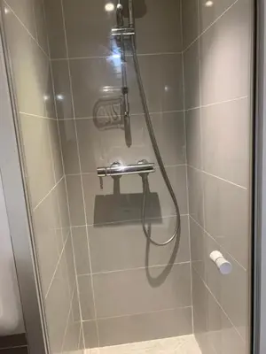 a shower with a hose in a bathroom at Chante Brise Studio in Cannes