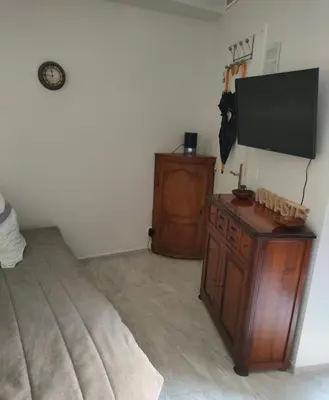 a bedroom with a bed and a flat screen tv at Chante Brise Studio in Cannes