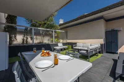a white table and chairs on a patio at LB Vacation Rentals I A Quiet Place with Terrace in the Heart of Cannes in Cannes