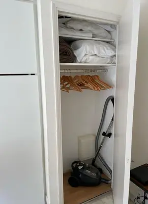 a room with a closet with a vacuum at studio standing cannes croisette in Cannes