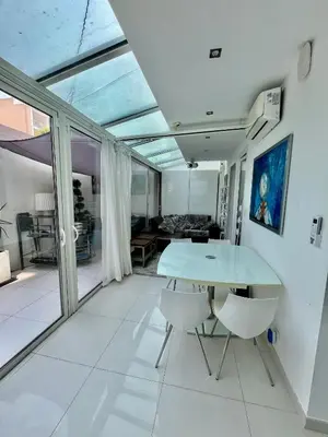 a dining room with a table and two chairs at Jardin sur la Pointe Croisette Luxe en Bord de Mer in Cannes