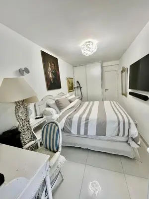 a white bedroom with a large bed and a desk at Jardin sur la Pointe Croisette Luxe en Bord de Mer in Cannes