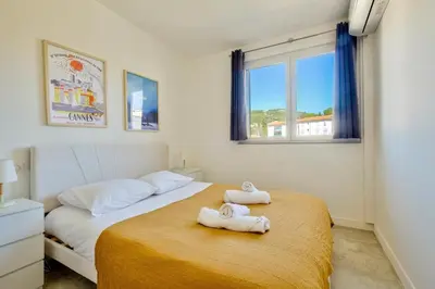 a bedroom with two beds with towels on them at Cosy 1 BR Flat with balcony near La Croisette in Cannes