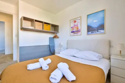 a bedroom with a bed with towels on it at Cosy 1 BR Flat with balcony near La Croisette in Cannes
