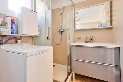 a small bathroom with a sink and a shower at Cosy 1 BR Flat with balcony near La Croisette in Cannes