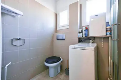 a small bathroom with a toilet with a black seat at Cosy 1 BR Flat with balcony near La Croisette in Cannes