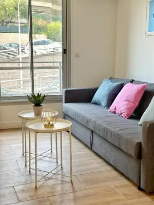 a living room with a couch and a table at Studio cosy au cœur de Cannes in Cannes