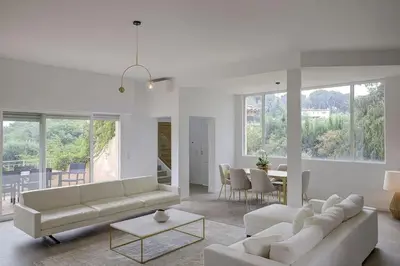 a living room with two couches and a table at La Villa Julia Two in Vallauris
