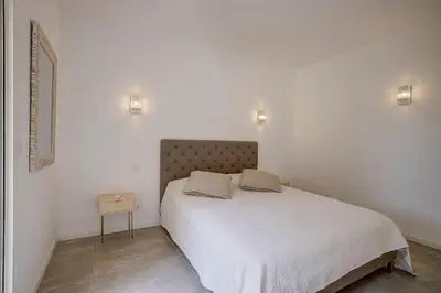 a bedroom with a bed with two pillows on it at La Villa Julia Two in Vallauris