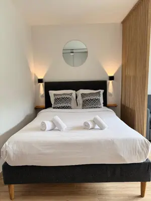 a bedroom with a large white bed with two pillows at Studio Riviera, Centre-ville Cannes, Terrasse, Clim in Cannes