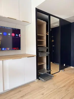 a living room with a tv and a closet at Studio Riviera, Centre-ville Cannes, Terrasse, Clim in Cannes