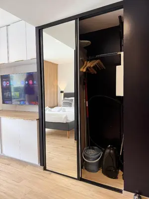 a room with a mirror and a bedroom with a bed at Studio Riviera, Centre-ville Cannes, Terrasse, Clim in Cannes