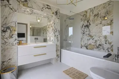 a bathroom with a white tub and a sink and a tubermott at Villa Julia First in Vallauris