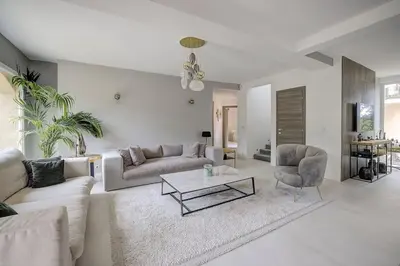 a living room with a couch and a table and a chair at Villa Julia First in Vallauris