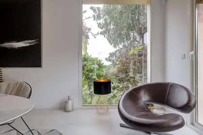 a leather chair sitting in a room with a window at Villa Julia First in Vallauris