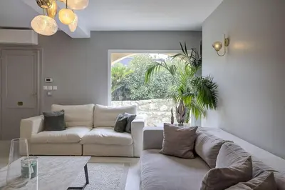 a living room with a couch and a table at Villa Julia First in Vallauris