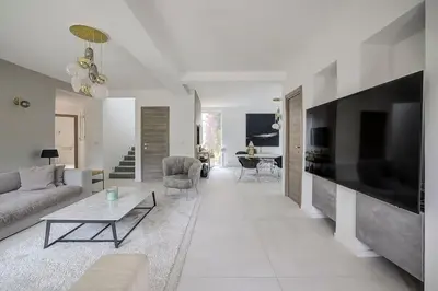 a living room with a couch and a tv at Villa Julia First in Vallauris