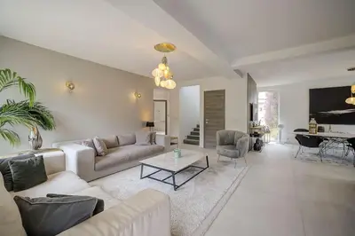 a living room with a couch and a table at Villa Julia First in Vallauris