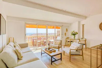 a living room with a couch and a table at LE VOILIER avec terrasse panoramique vue mer et port, proche du Palais, Croisette et plages in Cannes
