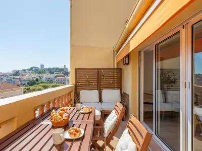 a balcony with a table with food on it at LE VOILIER avec terrasse panoramique vue mer et port, proche du Palais, Croisette et plages in Cannes