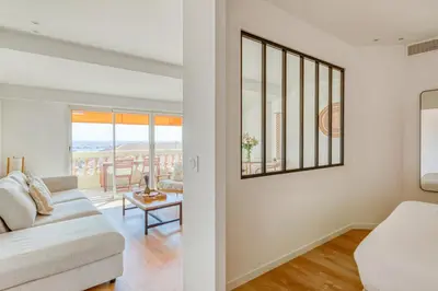 a living room with a couch and a table at LE VOILIER avec terrasse panoramique vue mer et port, proche du Palais, Croisette et plages in Cannes