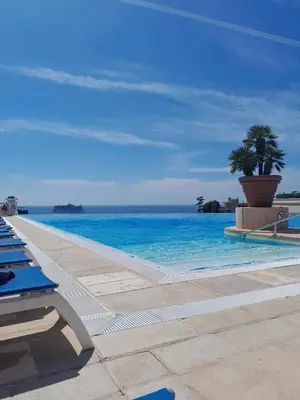 a swimming pool with a view of the ocean at Cannes Villa Francia appartement climatisé vue mer in Cannes
