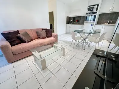 a living room with a couch and a table at Central 1 bedroom Riouffe 206 2 mins from Palais in Cannes