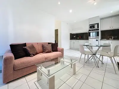 a living room with a couch and a table at Central 1 bedroom Riouffe 206 2 mins from Palais in Cannes