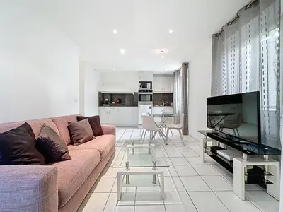 a living room with a couch and a flat screen tv at Central 1 bedroom Riouffe 206 2 mins from Palais in Cannes
