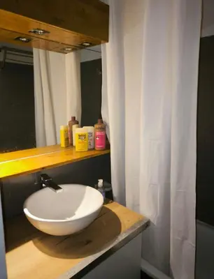 a bathroom with a white sink and a mirror at Appartement 4 personnes sea view pool in Cannes