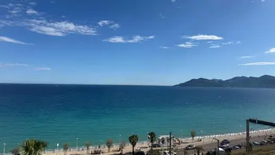 a view of the beach and the ocean at Appartement 4 personnes sea view pool in Cannes