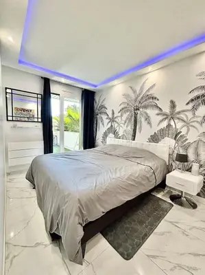 a bedroom with a large bed with palm trees on the wall at Gray D'Albion -2A8- 1 Chambre in Cannes