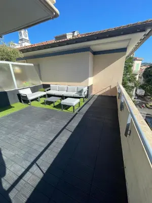 a patio with white benches on a roof at Cannes Appartement Terrasse Parking privé in Cannes