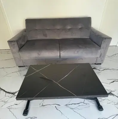a brown couch sitting on top of a marble floor at Cannes Appartement Terrasse Parking privé in Cannes
