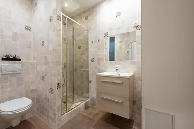 a bathroom with a shower and a toilet and a sink at Cannes 1-Br Apartment in the Carré d’Or in Cannes