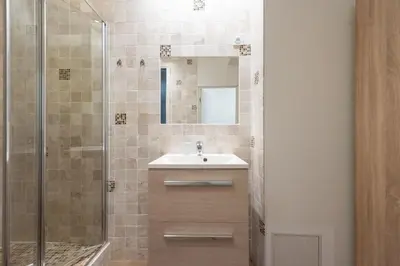 a bathroom with a sink and a shower at Cannes 1-Br Apartment in the Carré d’Or in Cannes