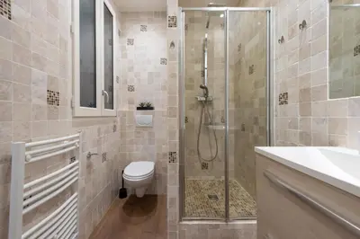 a bathroom with a shower and a toilet and a sink at Cannes 1-Br Apartment in the Carré d’Or in Cannes