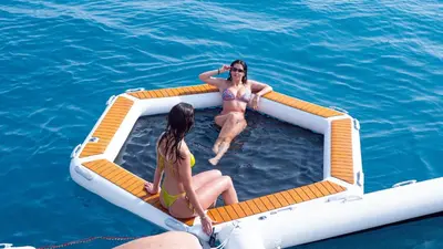 a deck of a boat with two chairs and a flag at Zaffiro Yacht - Festival de la plaisance Cannes 2024 in Cannes