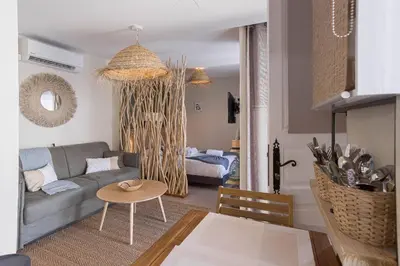 a living room with a couch and a table at Kaméa - Palais & plage, clim, vieux Suquet, port in Cannes